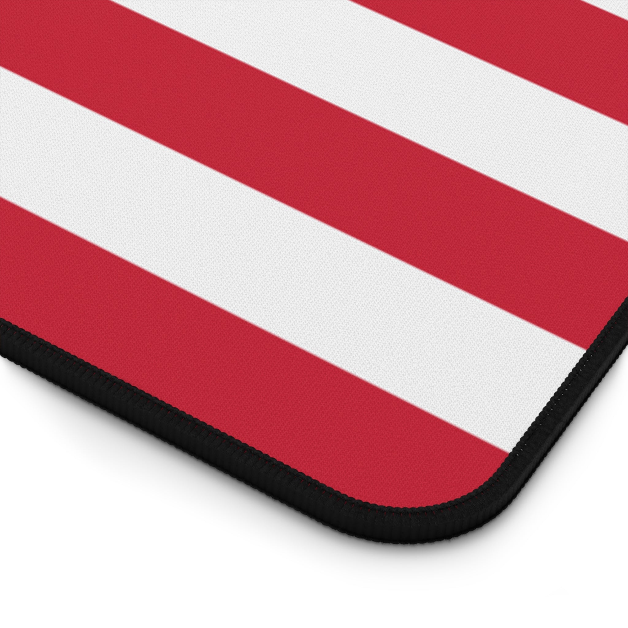 Close-up of a red and white striped mouse pad with a black border.