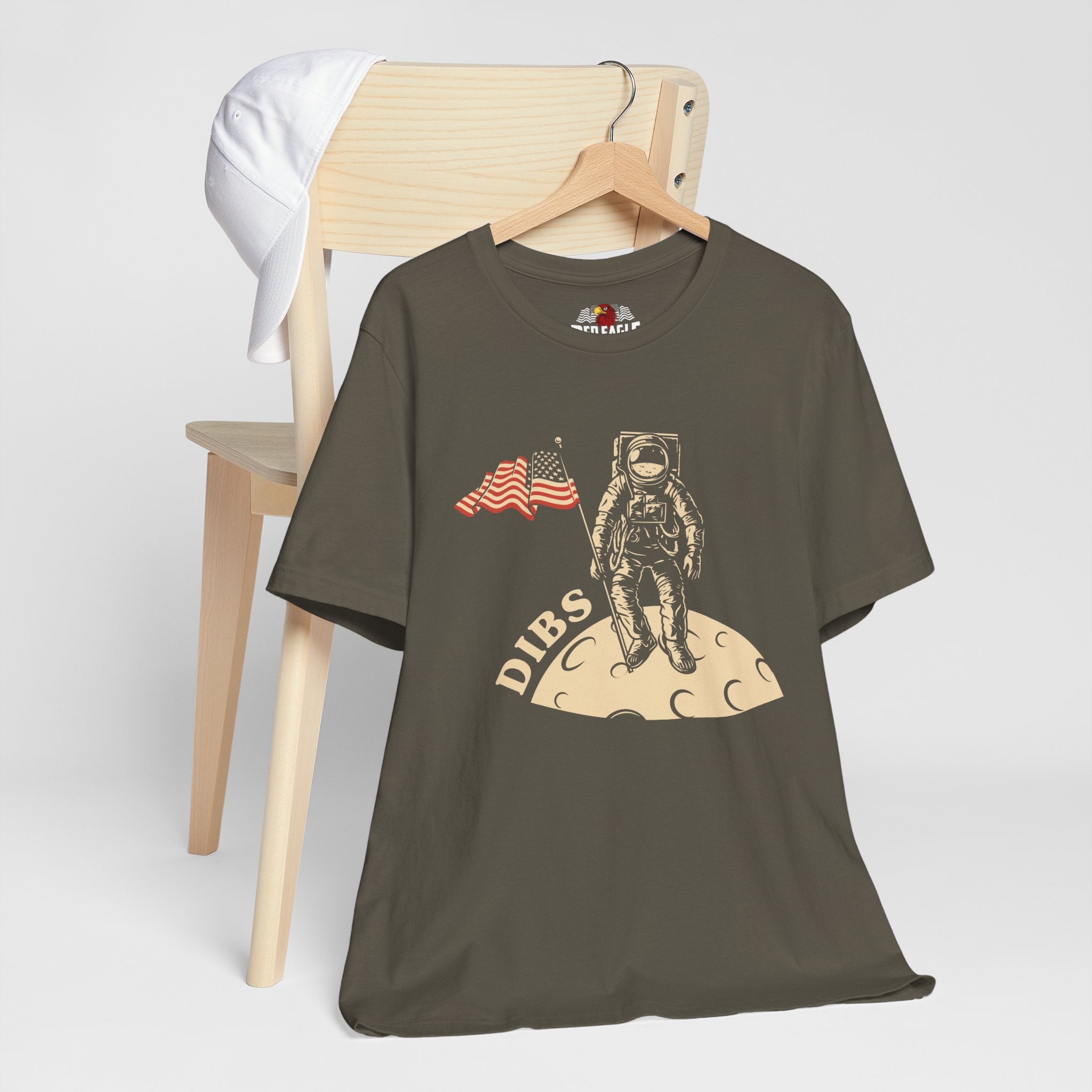 Army green t-shirt with astronaut graphic and 'DIBS' text on a white background