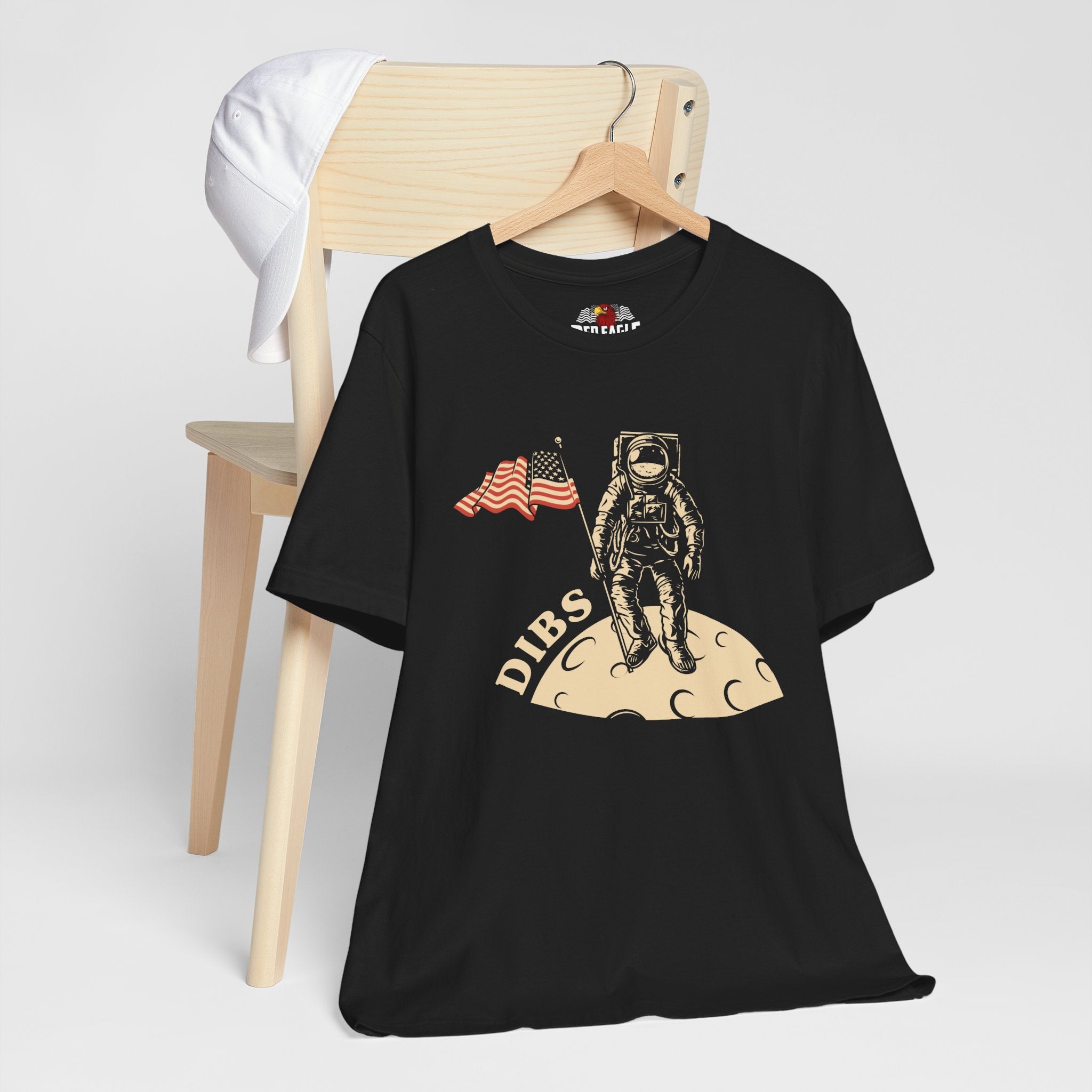 Black t-shirt with astronaut graphic and 'DIBS' text on a white background