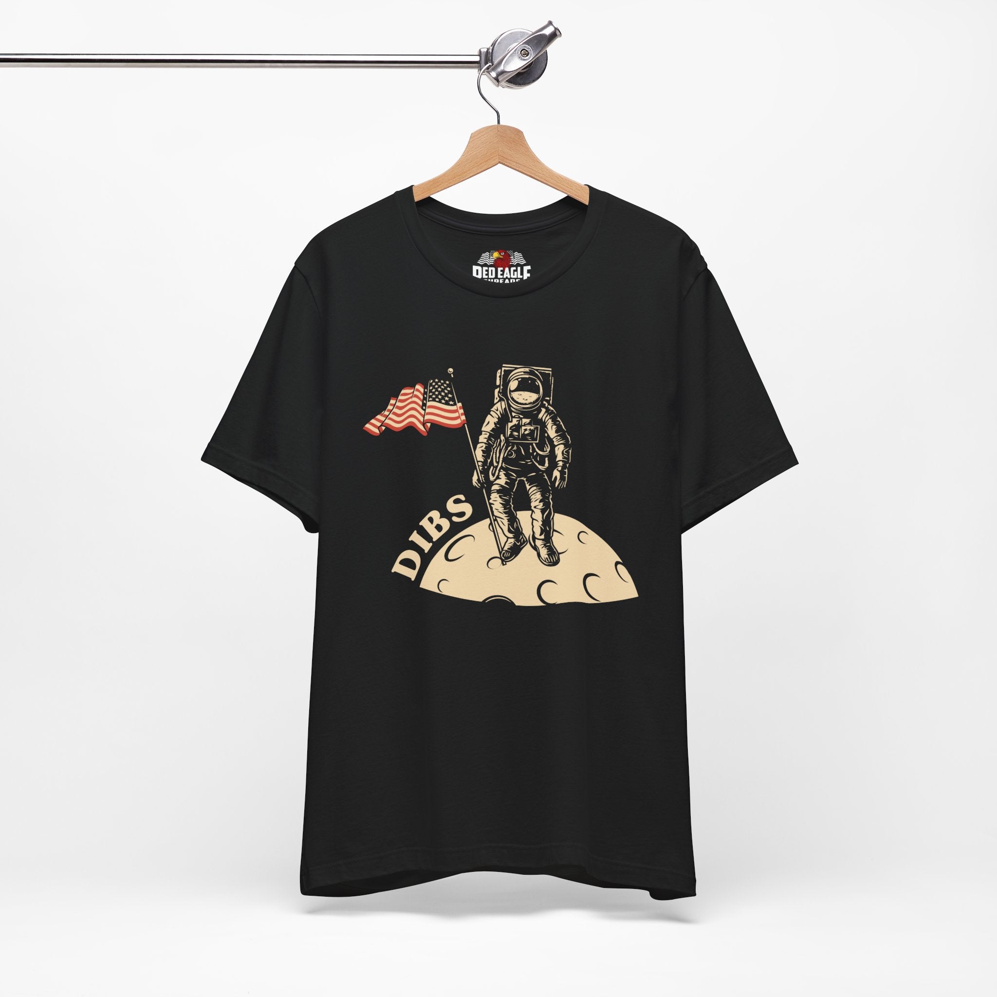 Black t-shirt with astronaut graphic and 'DIBS' text on a hanger against a white background
