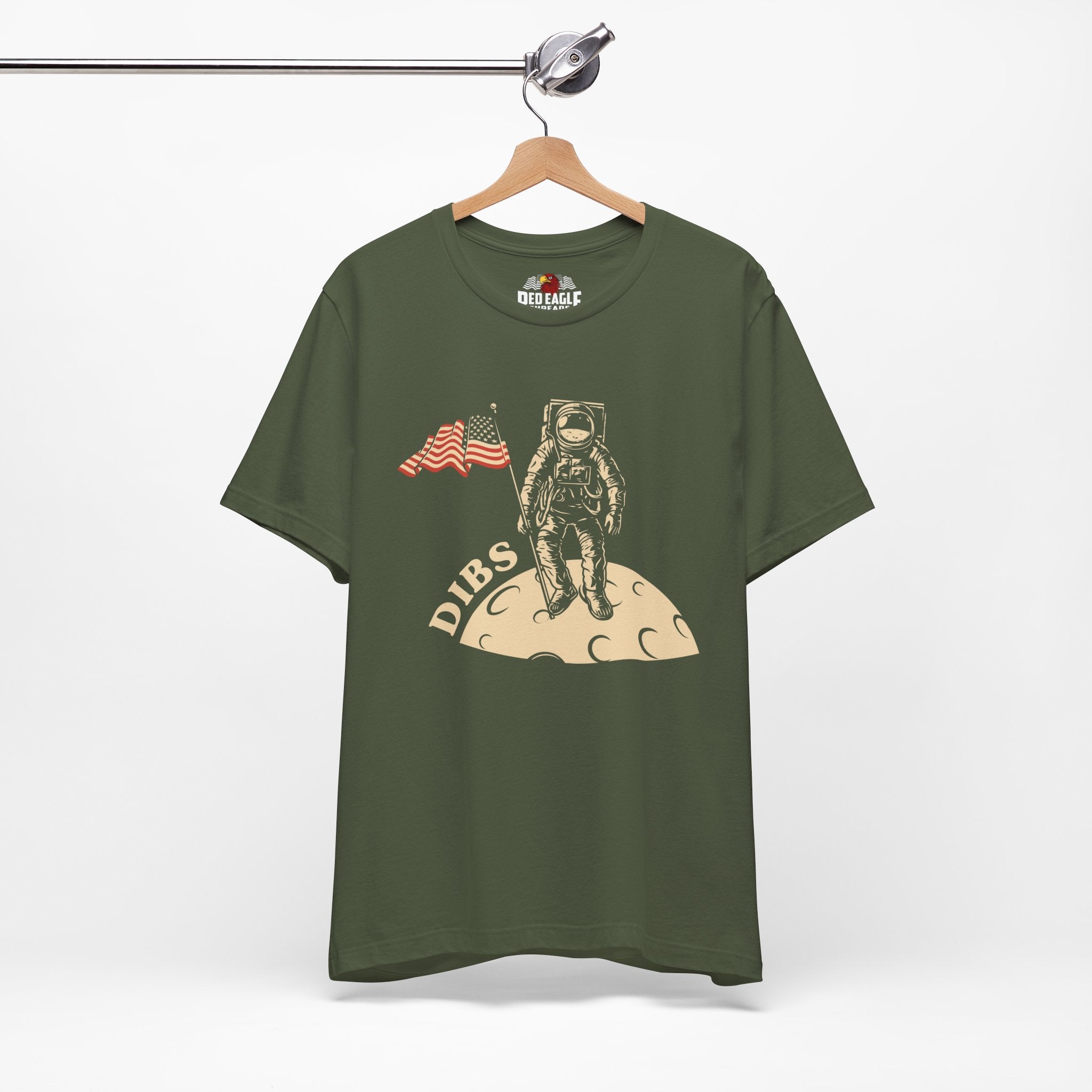 Military Green t-shirt with astronaut graphic and 'DIBS' text on a hanger against a white background