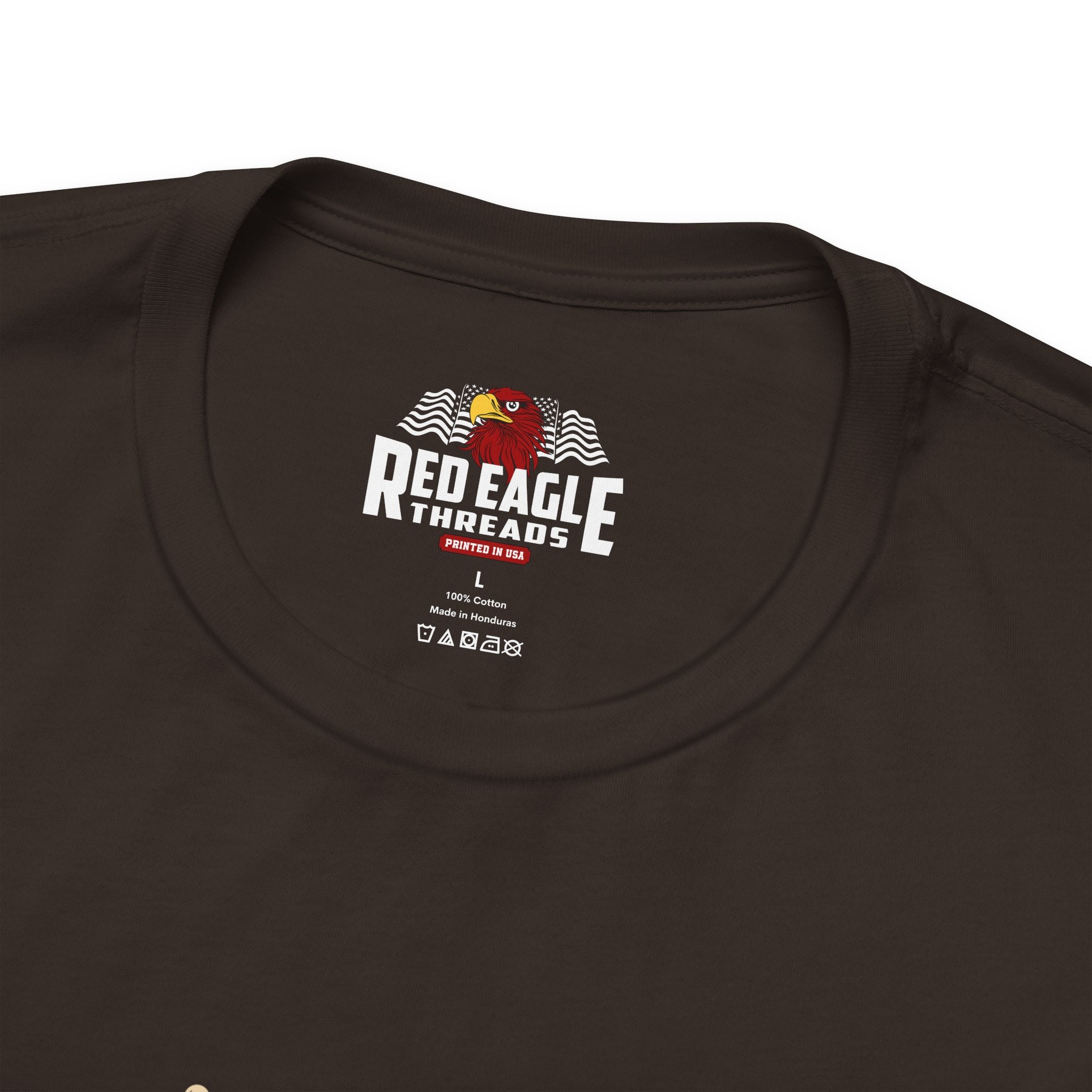 Close-up of a brown t-shirt with 'Red Eagle Threads' logo on a white background