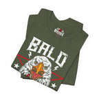 Folded military green t-shirt with an eagle graphic and 'Bald' text on a white background