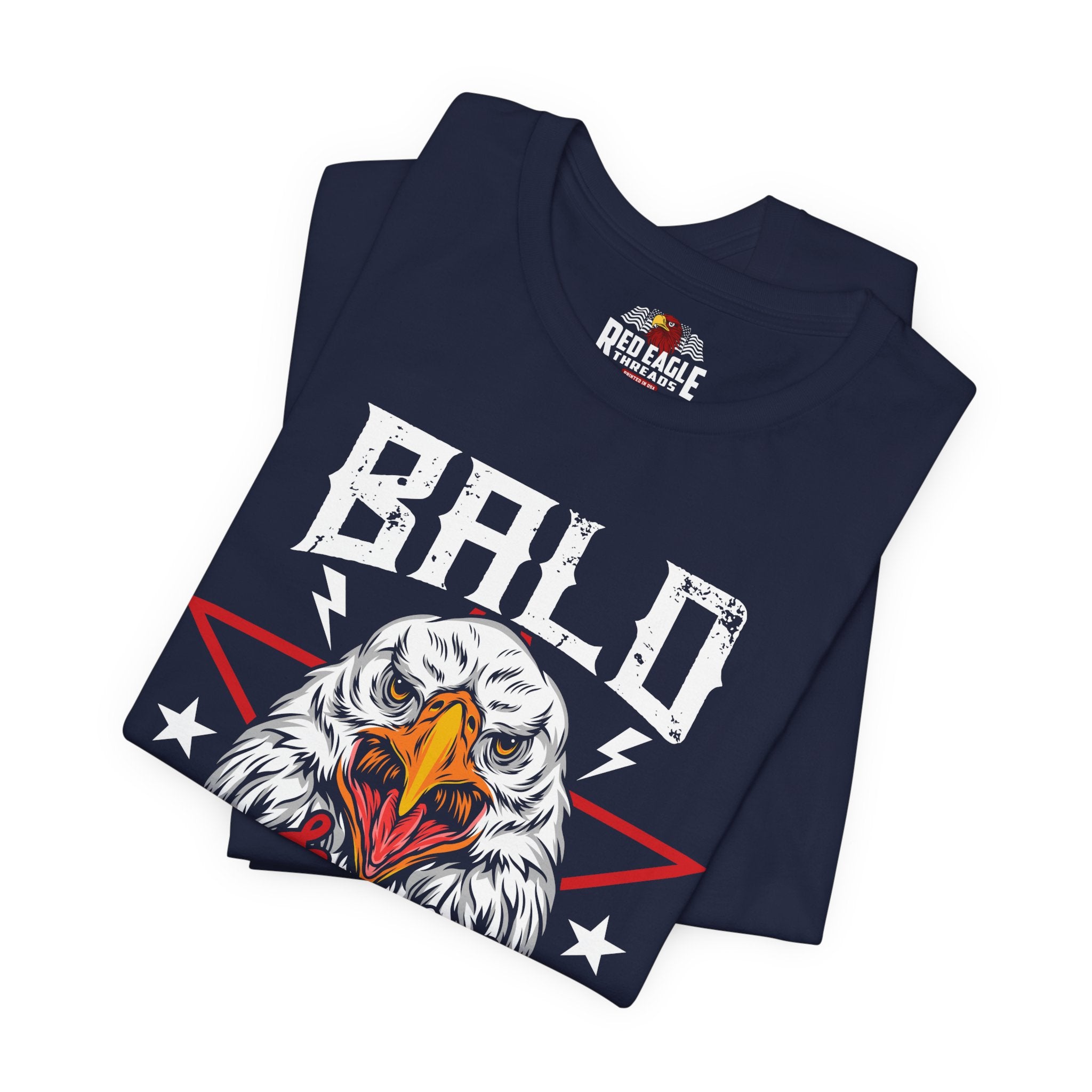 Folded navy blue t-shirt with an eagle graphic and 'Bald' text on a white background