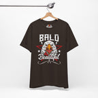 Brown t-shirt with bald eagle graphic and 'Bald is Beautiful' text on a hanger against a white background