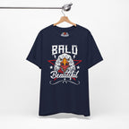 Navy blue t-shirt with an eagle graphic and 'Bald is Beautiful' text on a hanger against a white background.