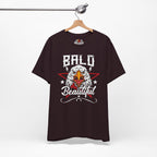 Oxblood Black t-shirt with bald eagle graphic and 'Bald is Beautiful' text on a hanger against a white background.