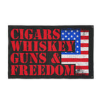 Flag with 'Cigars Whiskey Guns & Freedom' text and American flag design on a black background