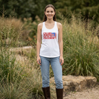 Woman wearing a white tank top with text standing in a natural setting