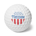 Golf ball with 'Freedom' and American flag design on a white background