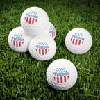Golf balls with 'Freedom' and American flag design on a grass background