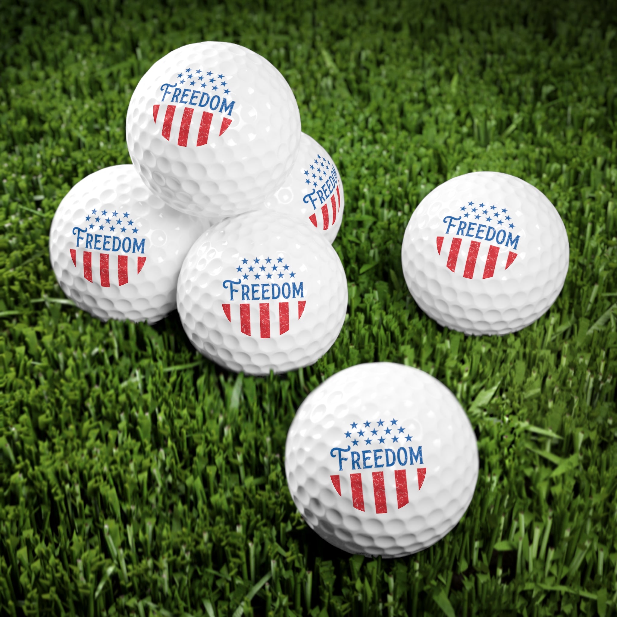 Golf balls with 'Freedom' and American flag design on a grass background