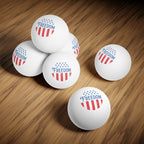 White ping pong balls with 'Freedom' and American flag design on a wooden surface