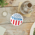 Coaster with 'FREEDOM' design on a wooden table