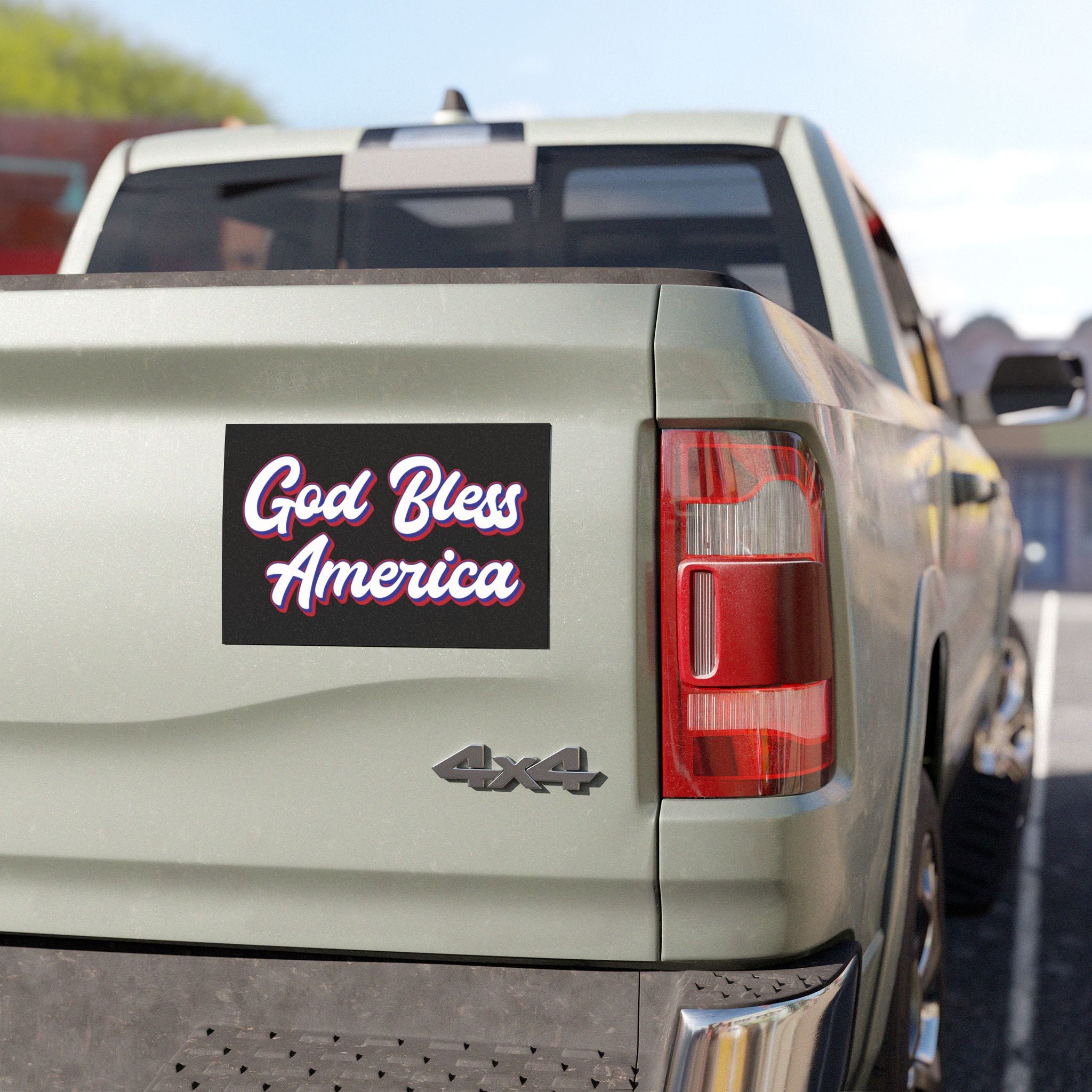 Back of a truck with 'God Bless America' magnet and '4x4' badge.
