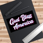 Black frame with a Vinyl Bumper Sticker with 'God Bless America' text on a wooden surface with pens and a ruler.
