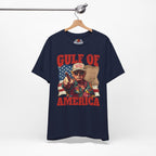Navy blue t-shirt with graphic design and text 'Gulf of America' on a hanger against a white background