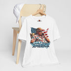 White t-shirt with graphic design of a person holding a phone in front of an American flag, sitting in a chair, with 'Gulf of America' text on a white background.