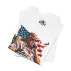 Folded white t-shirt with a graphic of a person holding a phone in front of an American flag.