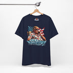 Navy blue t-shirt with graphic design of a person holding an American flag, hanging on a wooden hanger against a white background.