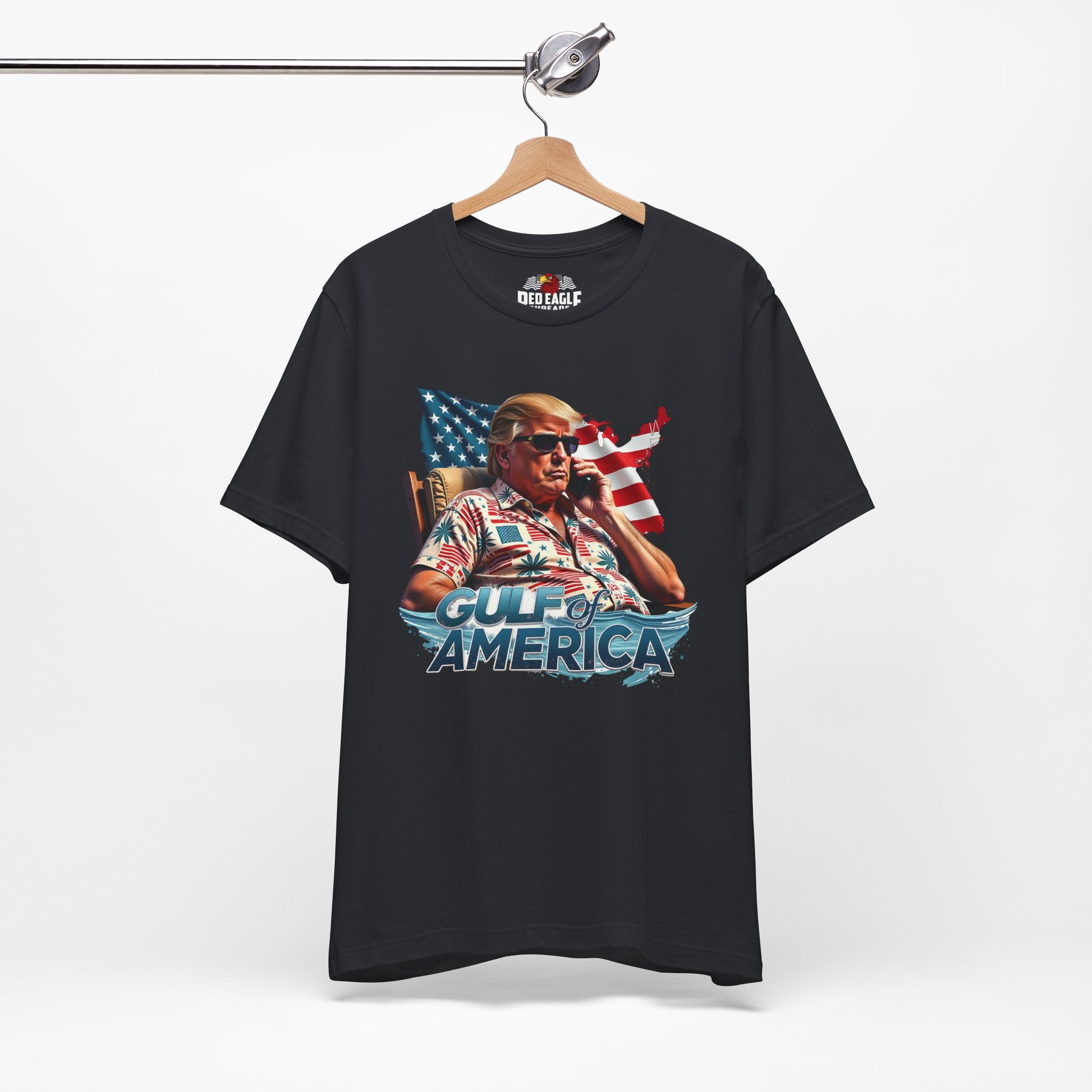 Vintage Black t-shirt with graphic design of a person on a phone with an American flag, hanging on a white background.