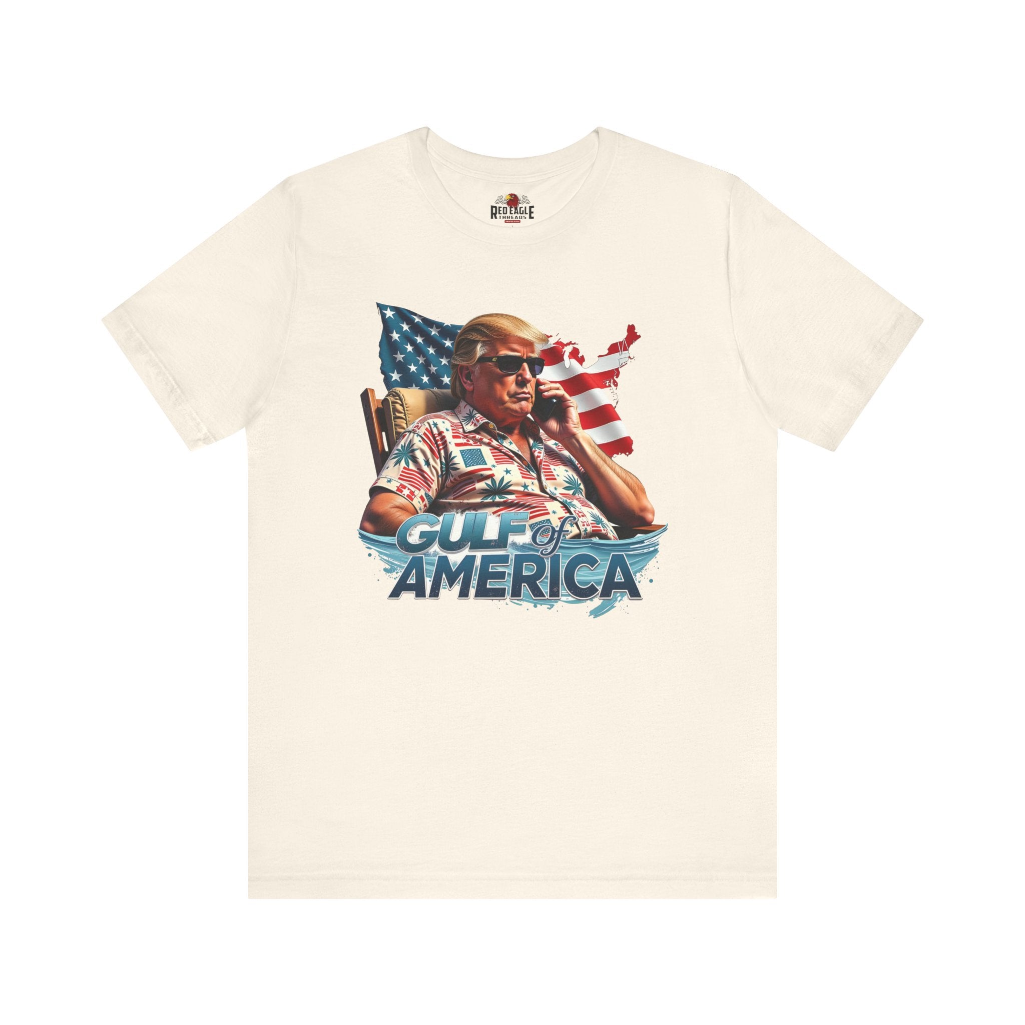 Natural t-shirt with graphic design of a person on a phone, American flag, and 'Gulf of America' text on a white background.