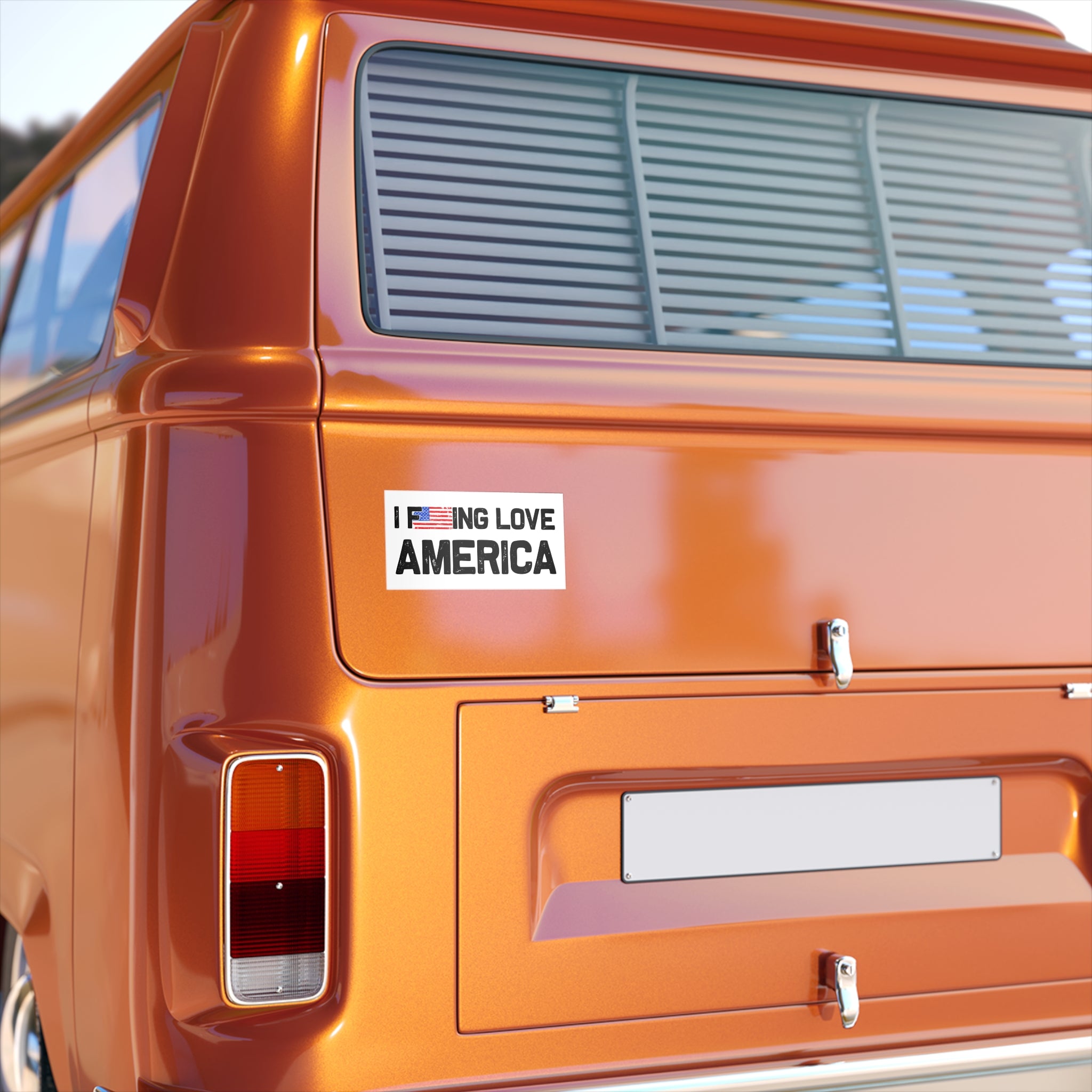 Orange vehicle with a 'I LOVE AMERICA' sticker on the back