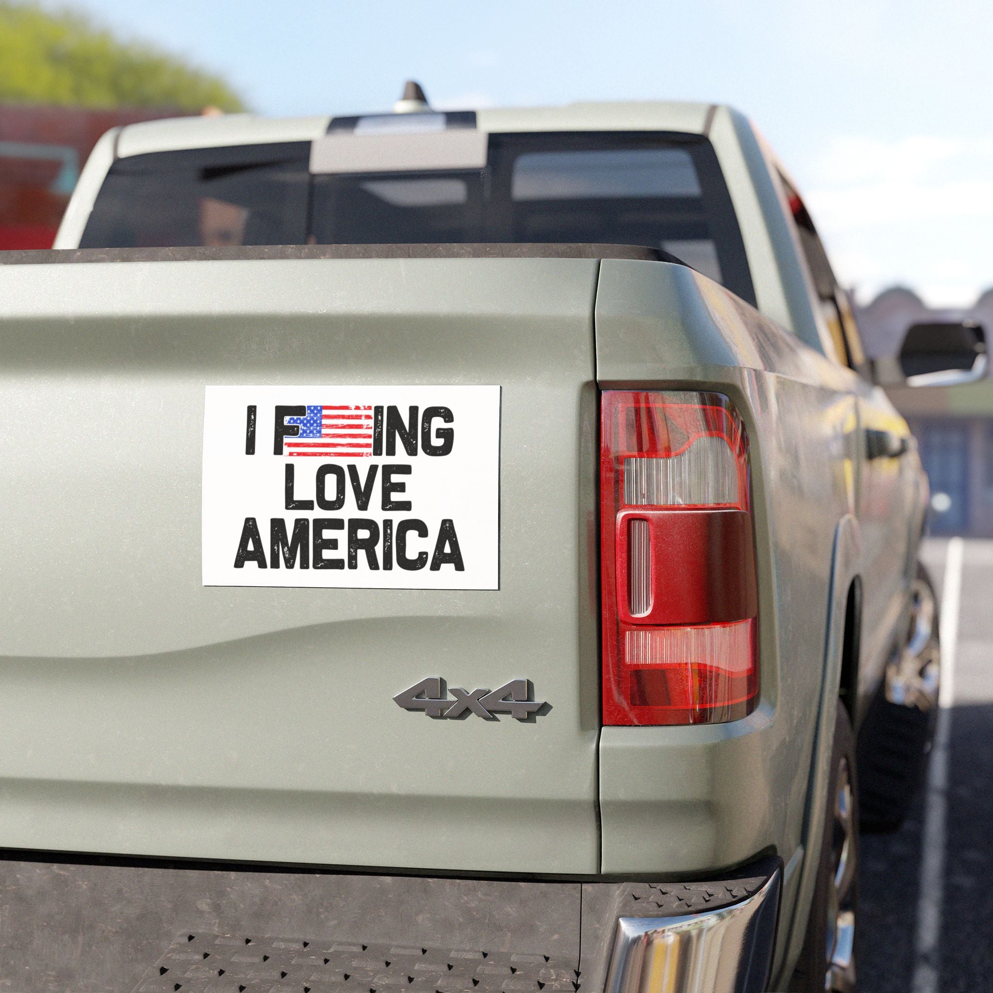 Back of a truck with a 'I F***ING LOVE AMERICA' magnet on a clear day.
