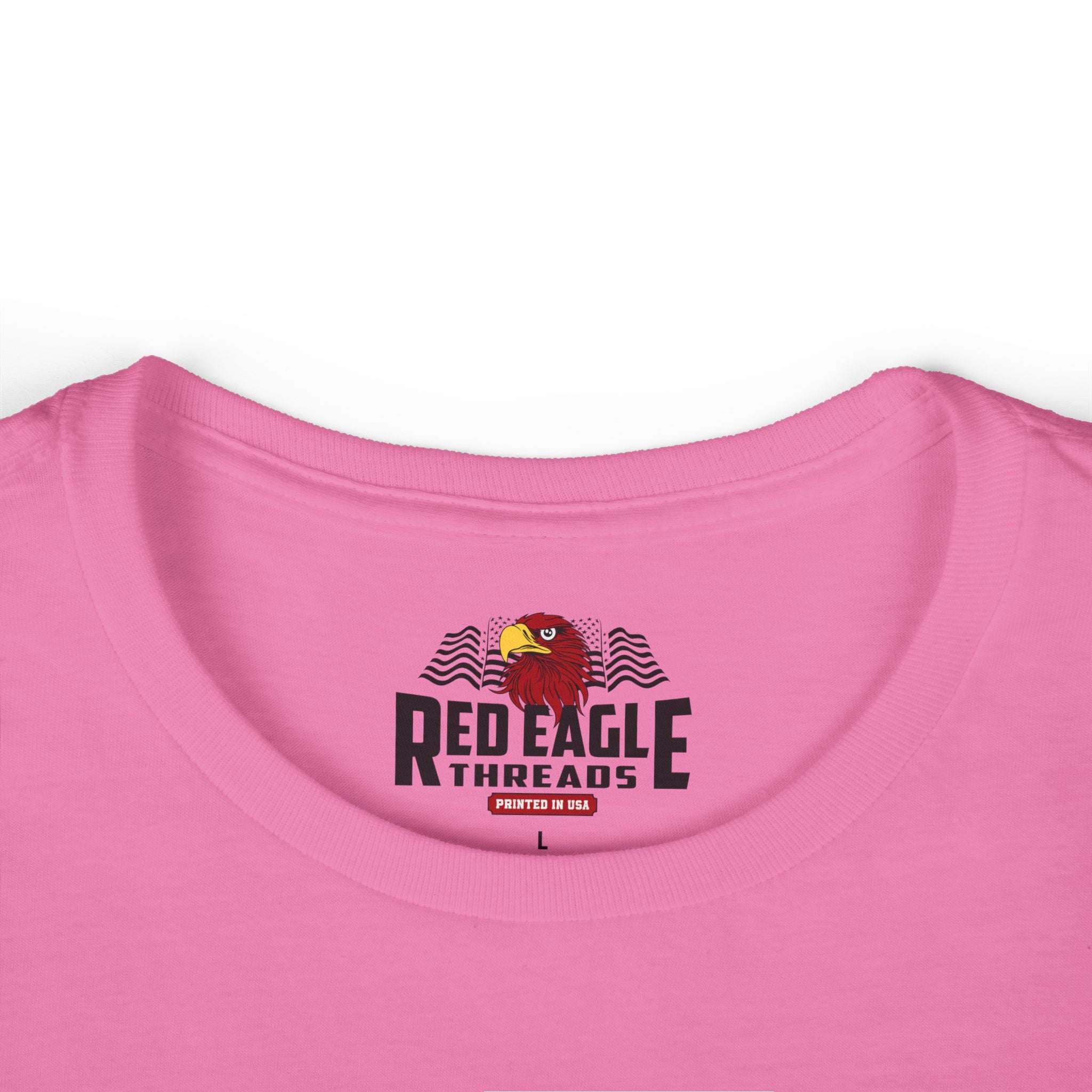 Close-up of a pink shirt with 'Red Eagle Threads' logo on a white background