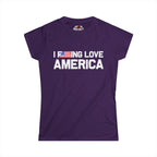 A purple short-sleeve t-shirt with the text 'I DOING LOVE AMERICA' printed in white across the chest, where the letter 'O' is replaced by a small American flag graphic. The shirt is displayed flat against a solid white background.
