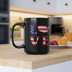 Black mug with 'LOVE' design featuring American flag colors on a kitchen counter.