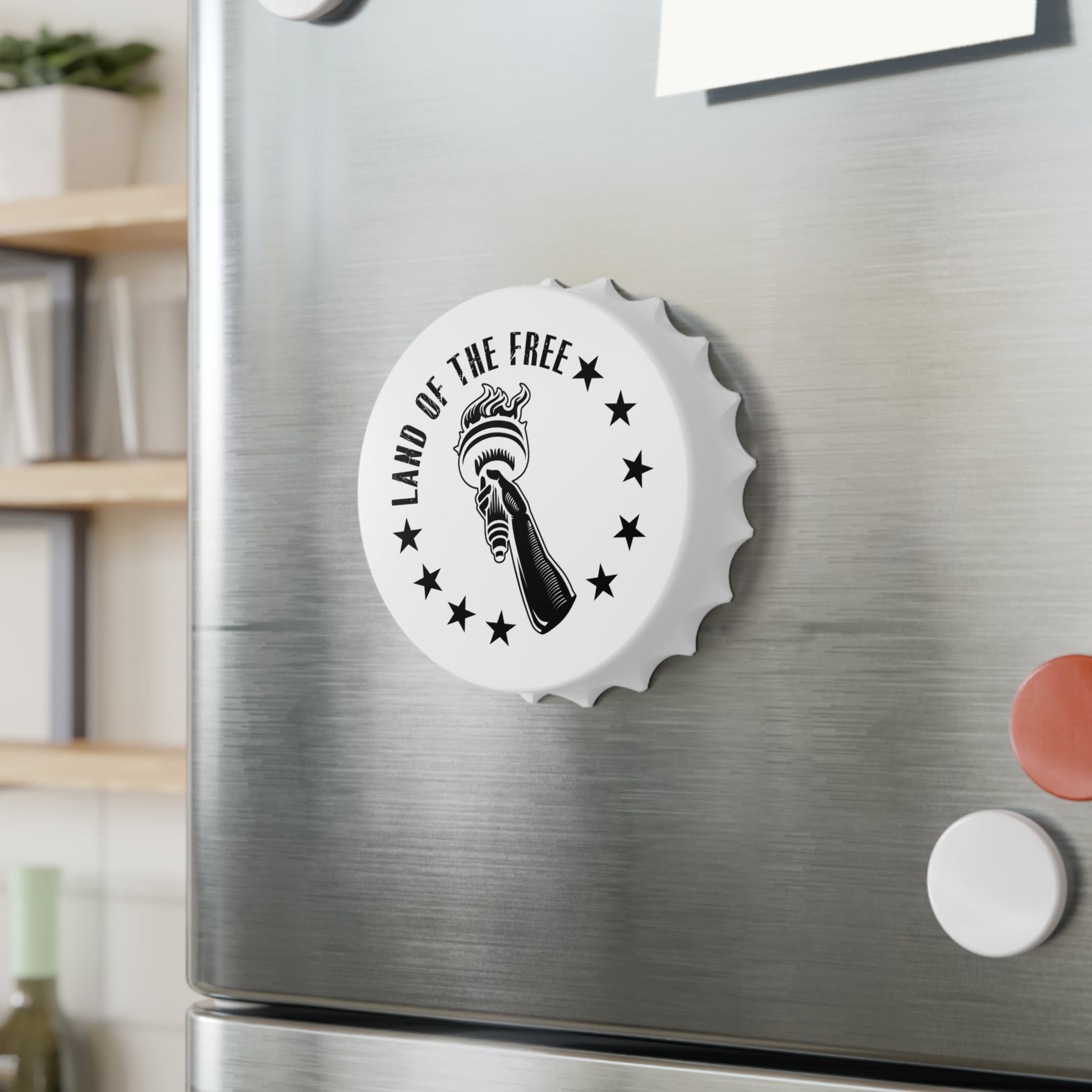 Bottle opener fridge magnet with 'Land of the Free' design on a metallic surface