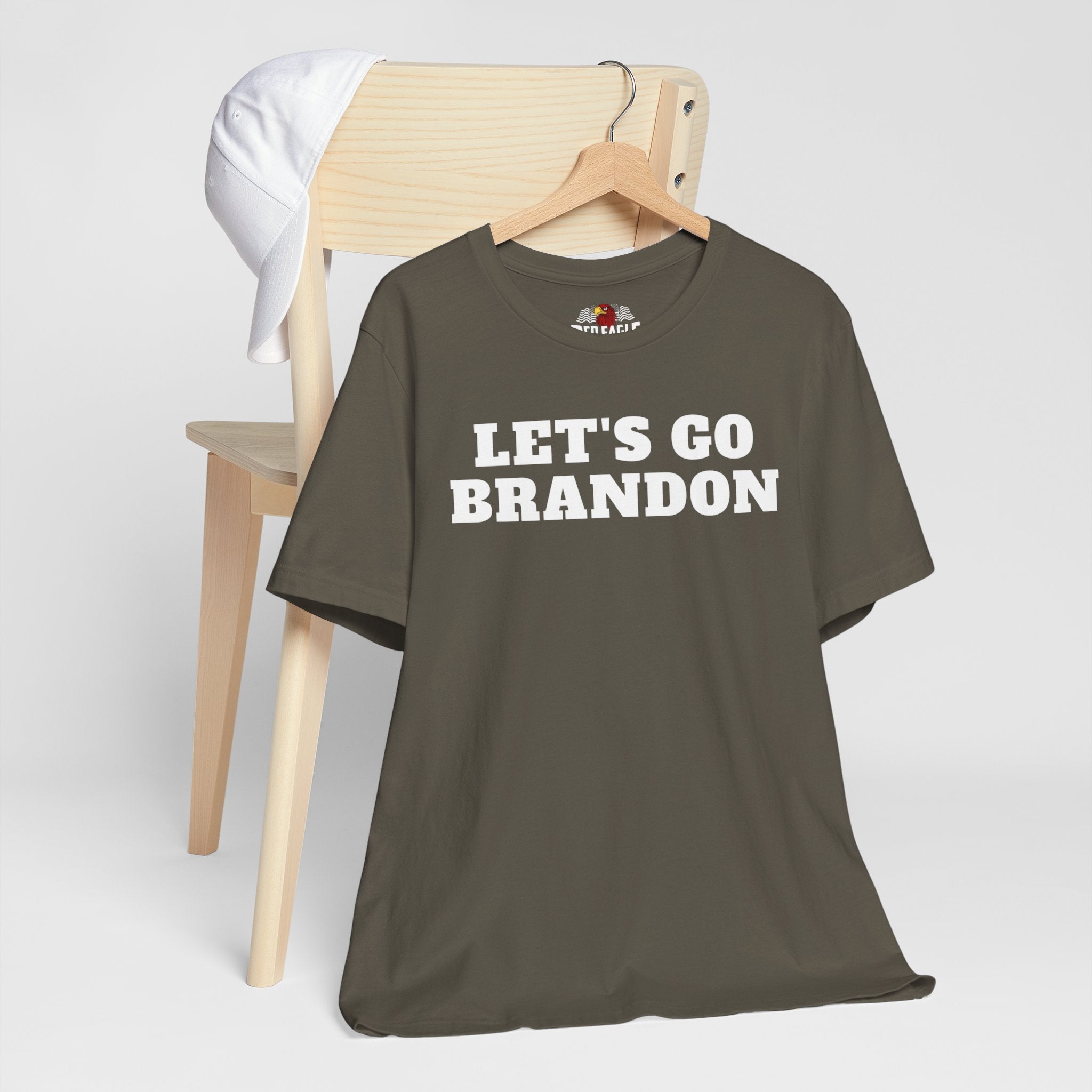 Army green t-shirt with 'LET'S GO BRANDON' text on a hanger against a white background