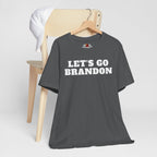 Asphalt t-shirt with 'LET'S GO BRANDON' text on a wooden chair against a white background