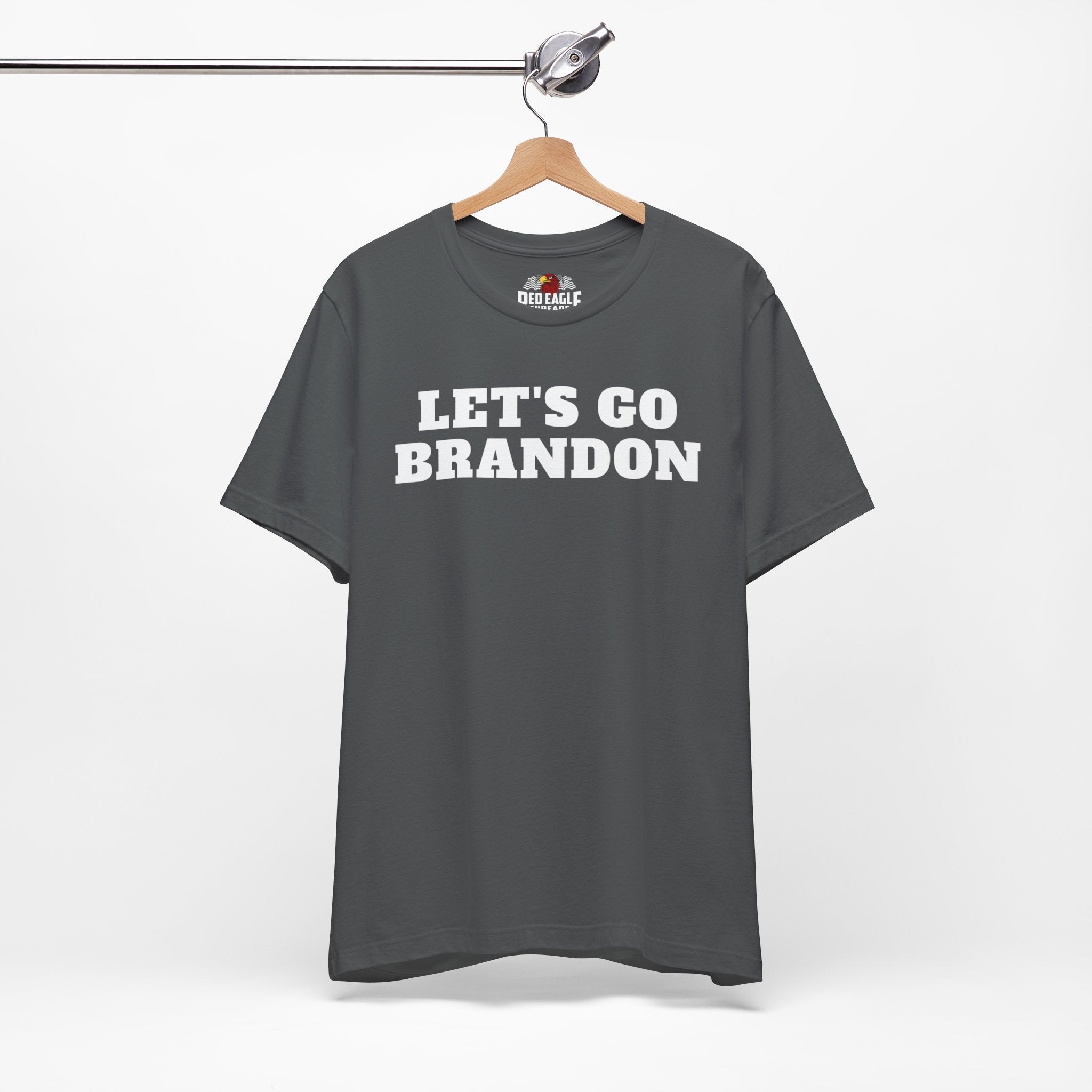 Asphalt t-shirt with 'LET'S GO BRANDON' text on a hanger against a white background