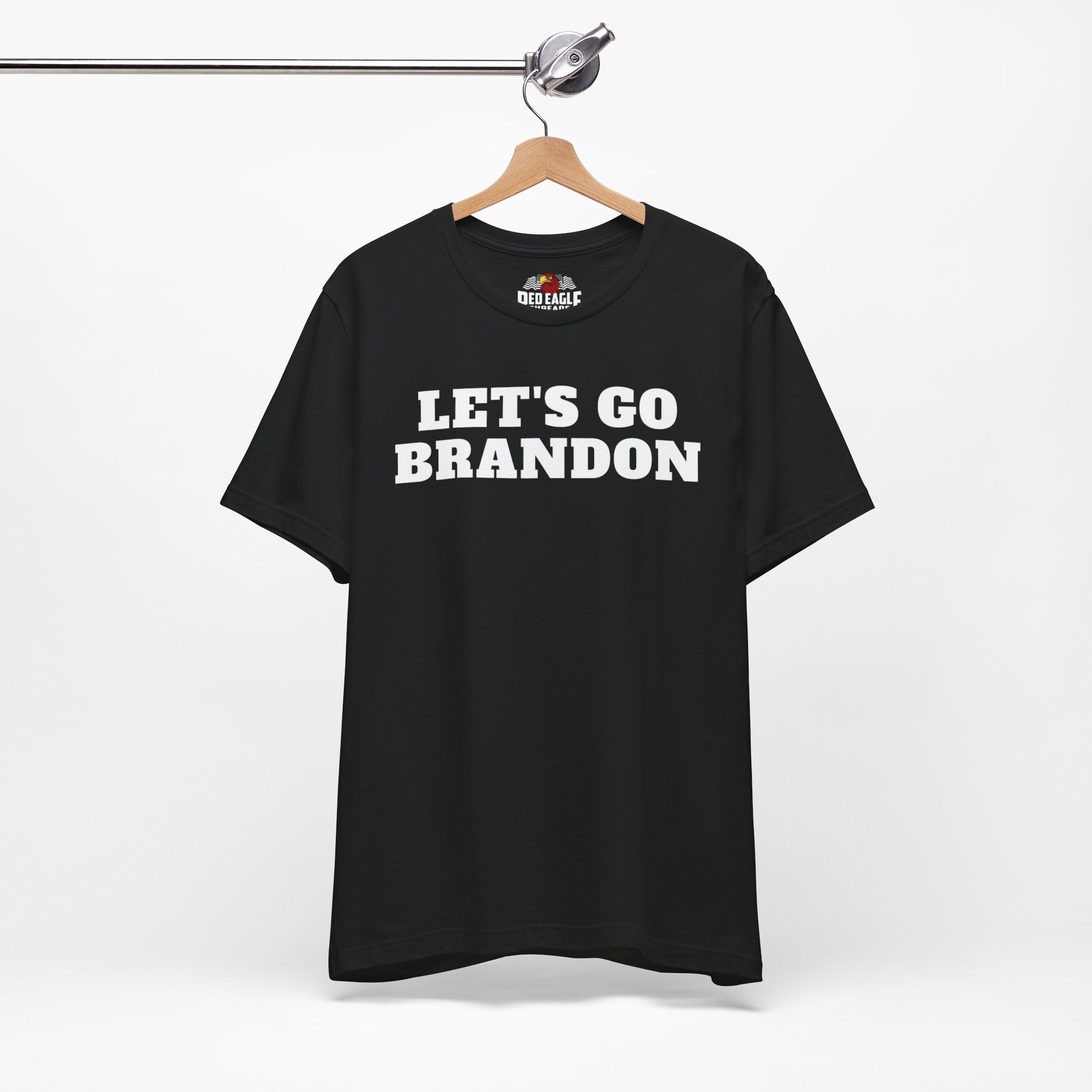 Black t-shirt with 'LET'S GO BRANDON' text on a hanger against a white background