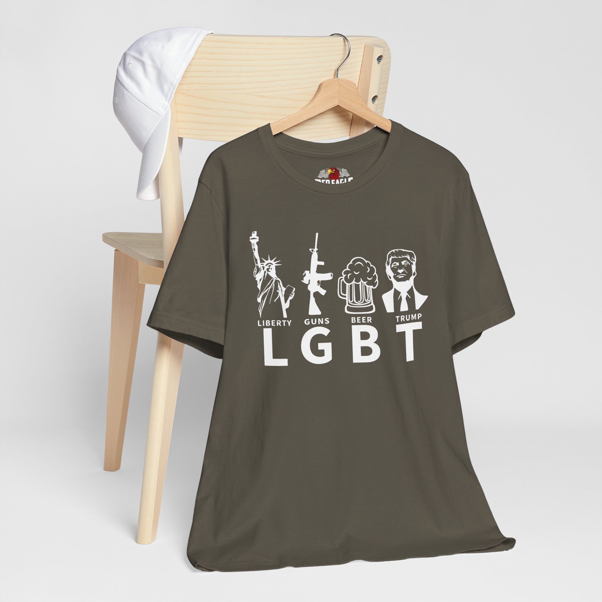 Brown t-shirt with white graphics and text on a wooden chair against a white background