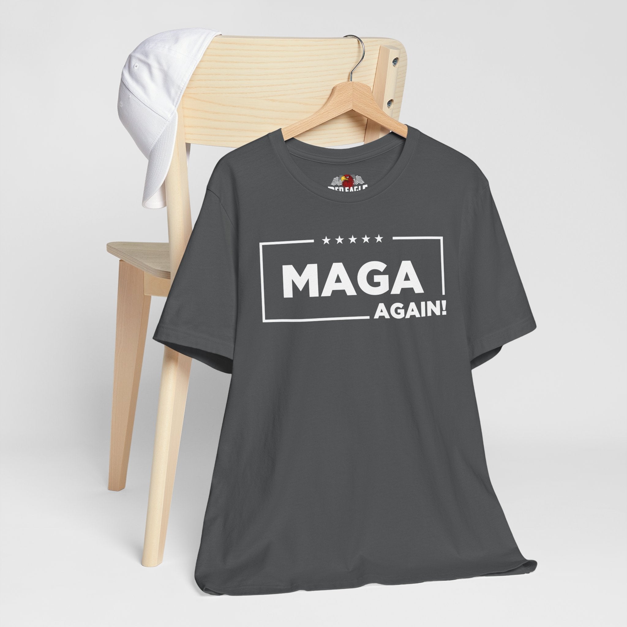 Asphalt t-shirt with 'MAGA Again!' text on a wooden chair against a white background