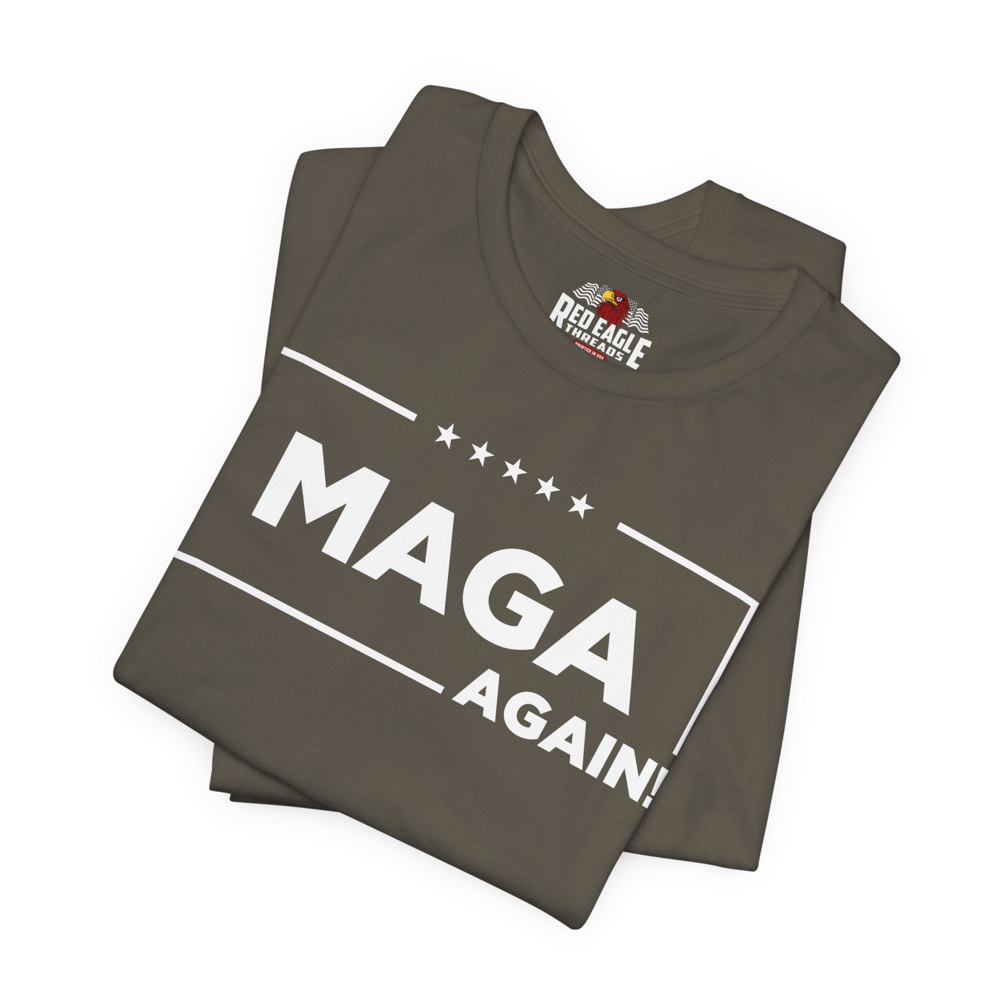Stack of folded brown t-shirts with 'MAGA AGAIN!' text and Red Eagle Apparel logo.