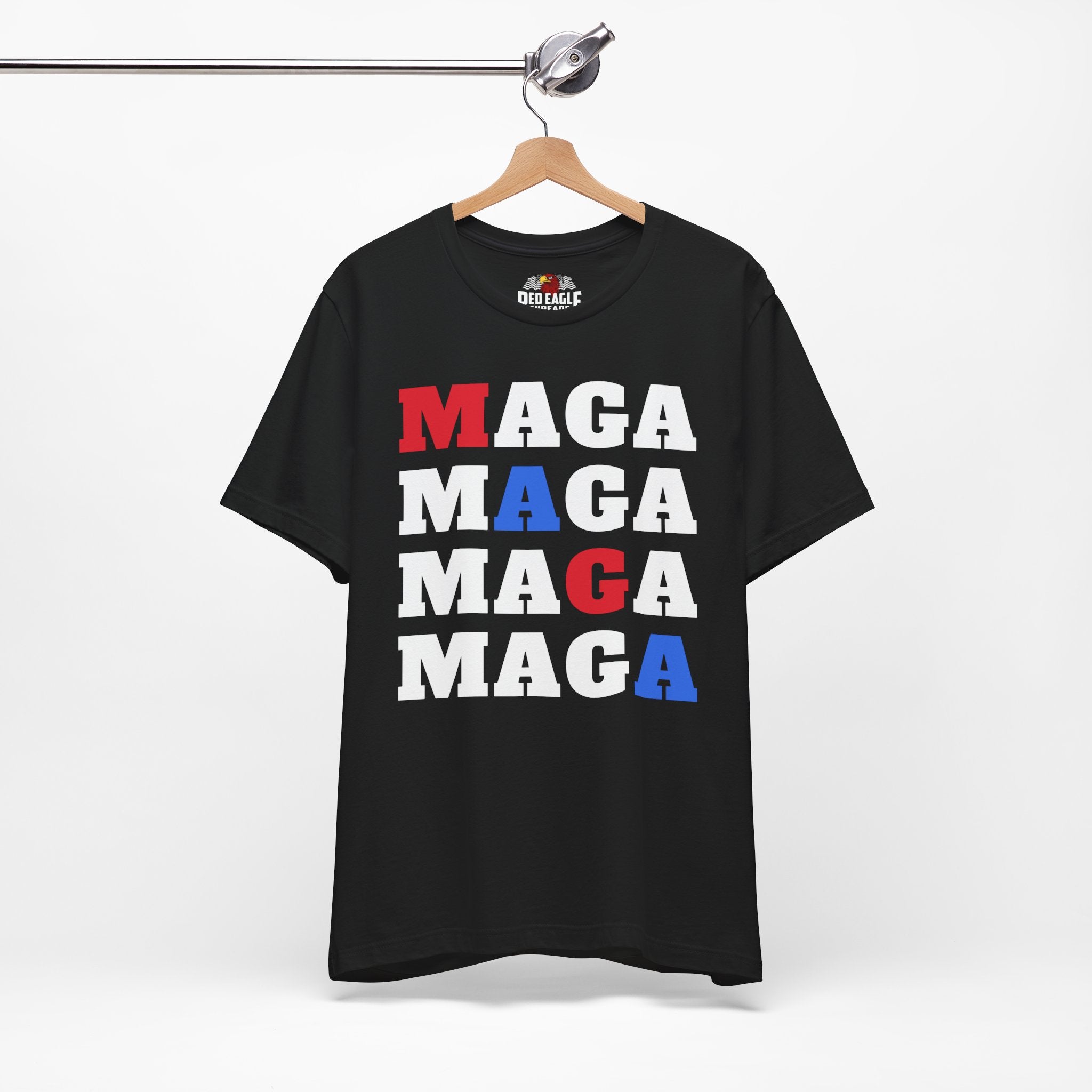 Black t-shirt with 'MAGA' text in red, white, and blue on a hanger against a white background.