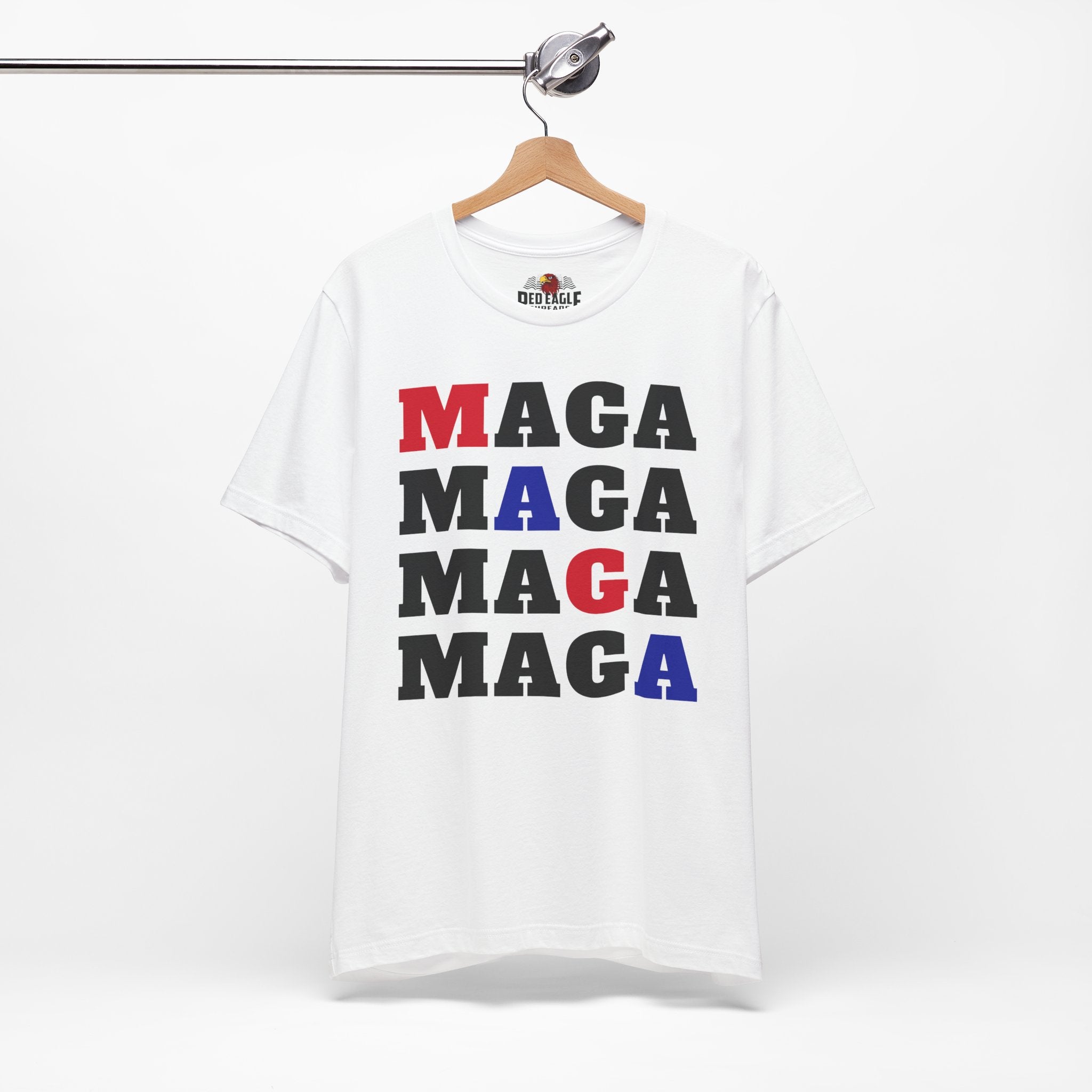 White t-shirt with 'MAGA' text in red, blue, and black on a hanger.