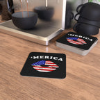 Coasters with 'MERICA' design on a wooden surface next to a coffee machine.