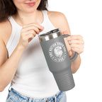 Person holding a gray travel mug with a logo and text on a white background