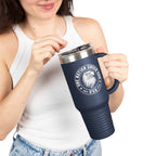 Person holding a navy blue travel mug with a logo and text on a white background