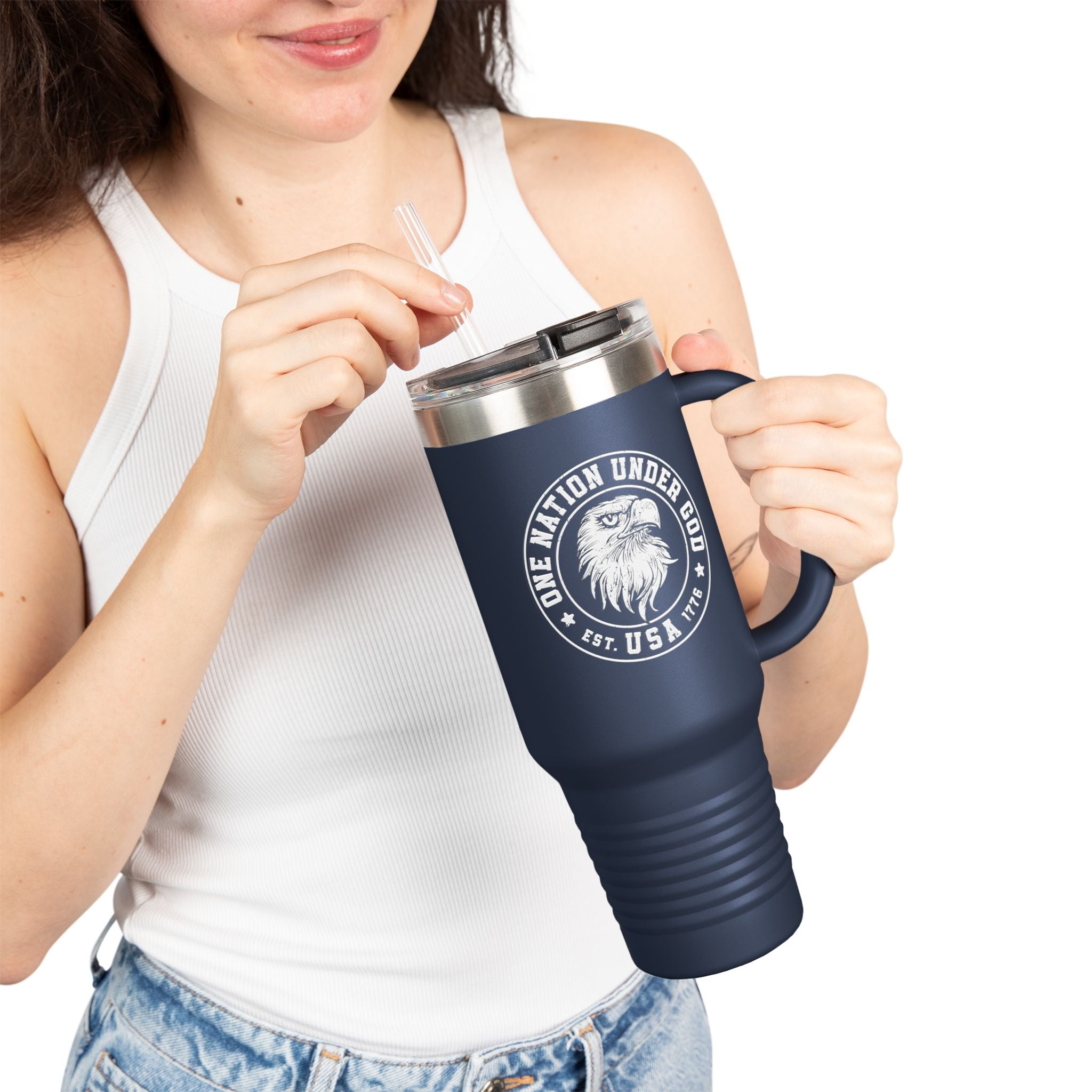 Person holding a navy blue travel mug with a logo and text on a white background