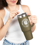 Person holding a green travel mug with a logo and text on a white background