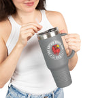 Person holding a gray travel mug with a logo and text on a white background