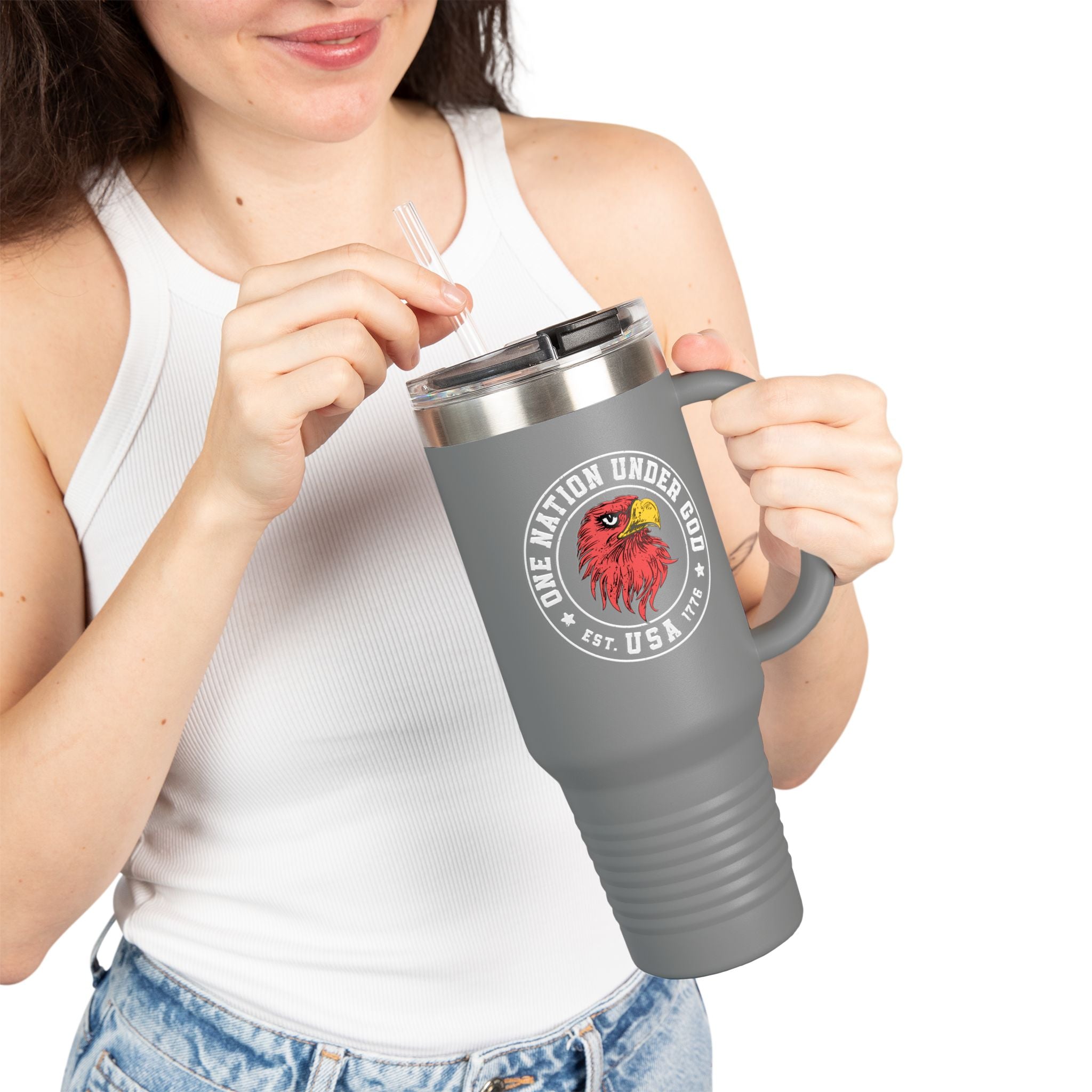 Person holding a gray travel mug with a logo and text on a white background