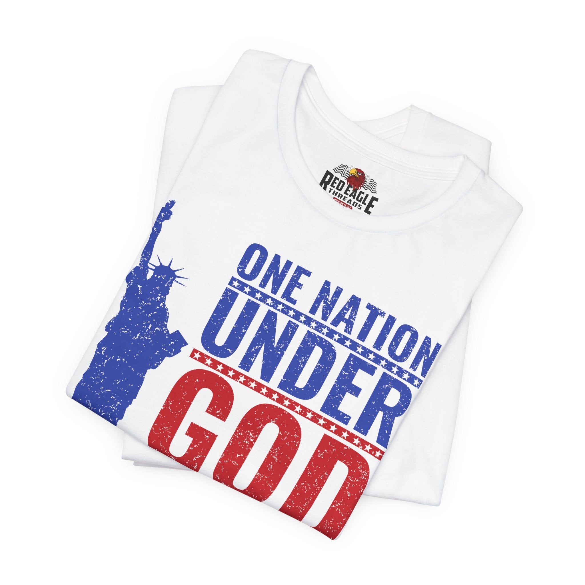 White t-shirt with 'One Nation Under God' design featuring the Statue of Liberty, folded on a white background.