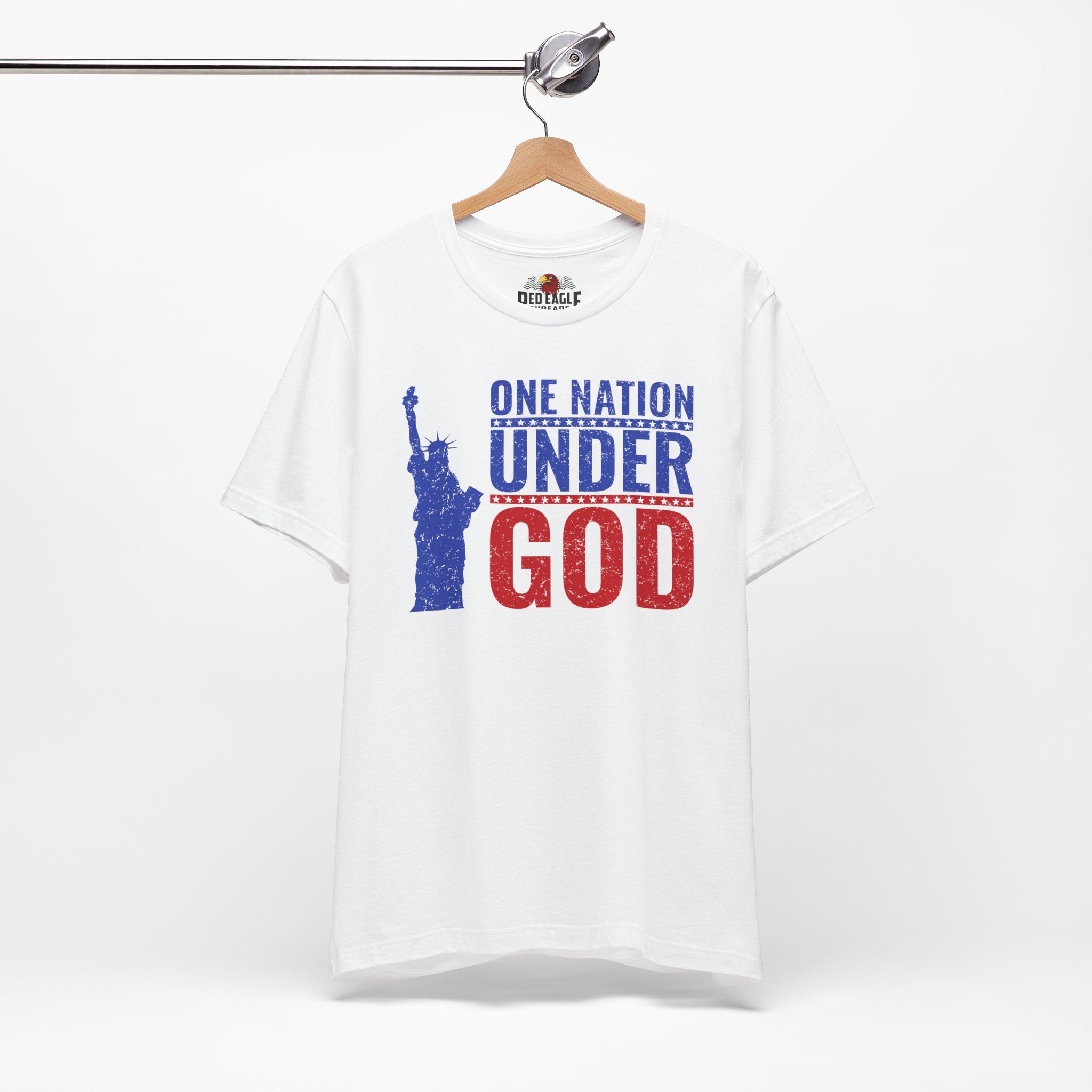White t-shirt with 'One Nation Under God' graphic and Statue of Liberty on a hanger against a white background.